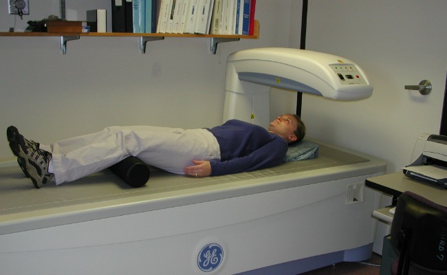 Person lying under Dexa Scanner