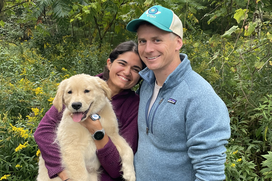 a woman and man and dog smiling