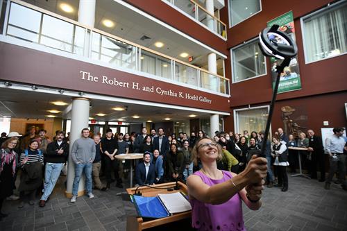 large group of people celebrating in a gallery 