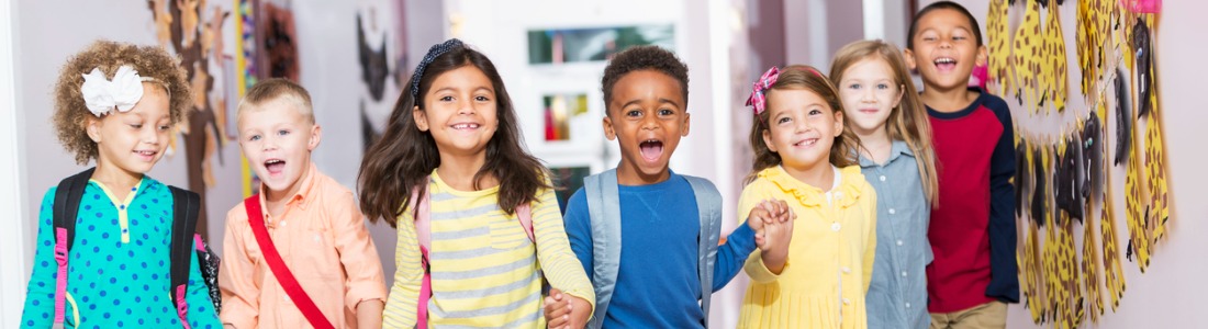 multiracial-group-of-preschoolers-running-down-hallway