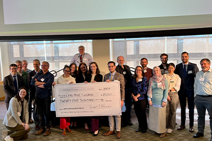 SiteFinity-NewsStory-SciRetreat24 members gather for a group photo and the presentation of a $25,000 check for their research proposal.