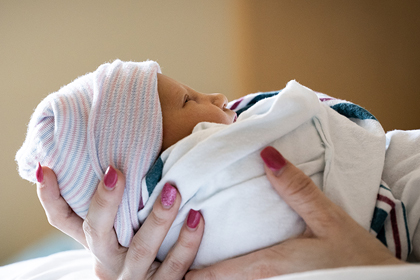 Person holding a newborn baby